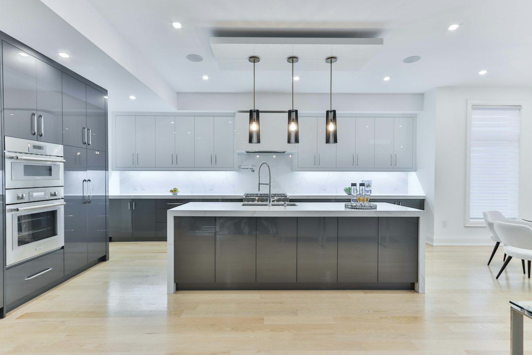 Modern modular kitchen with grey cabinets, island and pendant lighting